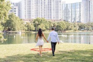 Emotional surprise proposal moment at Lake Eola in downtown Orlando captured by a professional Orlando proposal photographer.