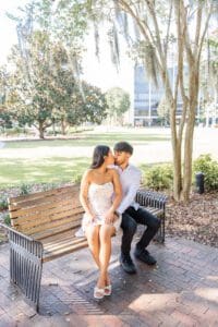 Candid portraits after a surprise proposal at Lake Eola showcasing downtown Orlando scenery and waterfront views.