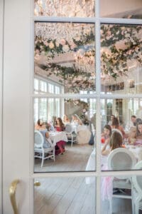 Two brides celebrate on the dance floor during a joyful Disney LGBTQ wedding reception at The Cake Bake Shop near Walt Disney World.