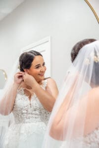 Bride getting into her wedding dress before her intimate Harry P. Leu Gardens wedding in Orlando.