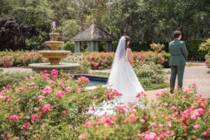 Bride and groom sharing a private first look in the Rose Garden at Harry P. Leu Gardens.