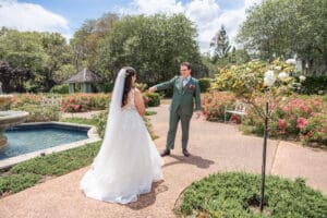 Bride and groom sharing a private first look in the Rose Garden at Harry P. Leu Gardens.