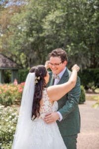 Bride and groom sharing a private first look in the Rose Garden at Harry P. Leu Gardens.