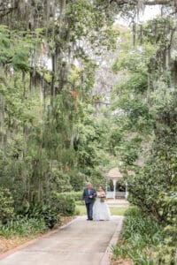 Bride walking down the garden aisle during an intimate wedding ceremony at Harry P. Leu Gardens.