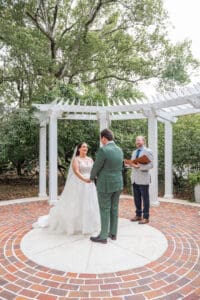Bride and groom exchanging personal vows during their Orlando garden wedding ceremony captured by top Orlando micro wedding photographer.