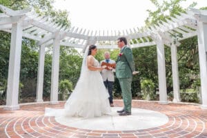 Bride and groom exchanging personal vows during their Orlando garden wedding ceremony captured by top Orlando micro wedding photographer.