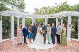 Bride and groom posing with their closest family during an intimate micro wedding.