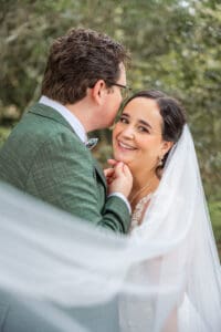 Bride and groom laughing together during relaxed garden portraits in Orlando by top wedding and elopement photographer