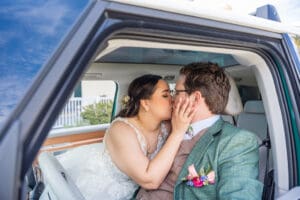 Bride and groom climbing into their getaway VW bus after their Harry P. Leu Gardens wedding.