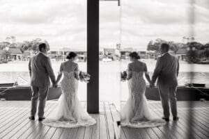 Romantic reflection portrait of the bride and groom overlooking the lagoon at Evermore Resort in Orlando, Captured by Elle's wedding photography team
