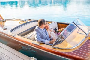 Romantic newlywed portraits aboard a classic wooden boat at Evermore Resort in Orlando. Captured by Elle's award-winning wedding photography team