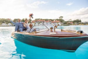 Just married! The couple celebrates with a joyful boat ride at Evermore Resort in Orlando, beautifully Captured by Elle wedding photography & videography