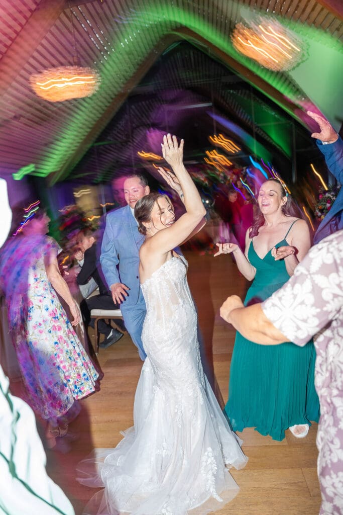 The celebration comes alive on the dance floor at Evermore Resort in Orlando with vibrant wedding photography by Captured by Elle's creative team