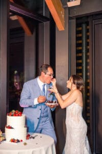 The newlyweds share a sweet cake-cutting moment at Evermore Resort in Orlando, photographed by Captured by Elle, top wedding photographer & videographer