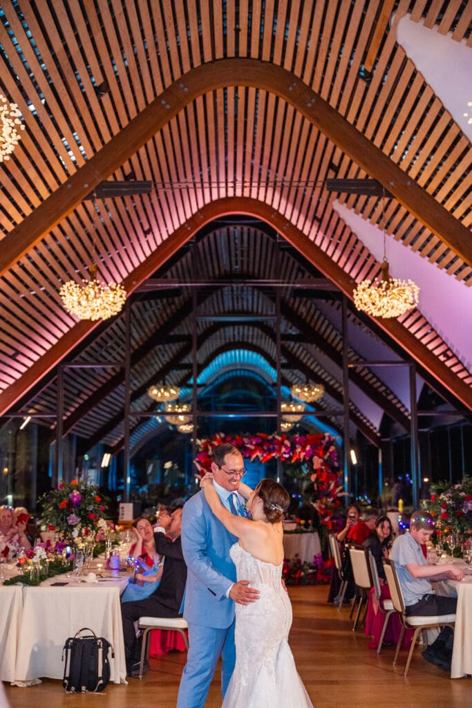 A romantic first dance beneath the stunning architecture of Evermore Resort in Orlando, beautifully captured by Captured by Elle, top wedding photographer & videographer