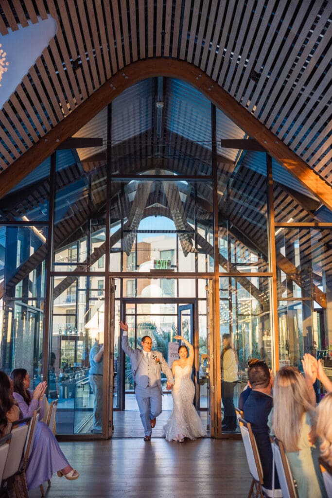 A joyful grand entrance at Evermore Resort showcases an unforgettable Orlando wedding celebration captured by Captured by Elle photography & film