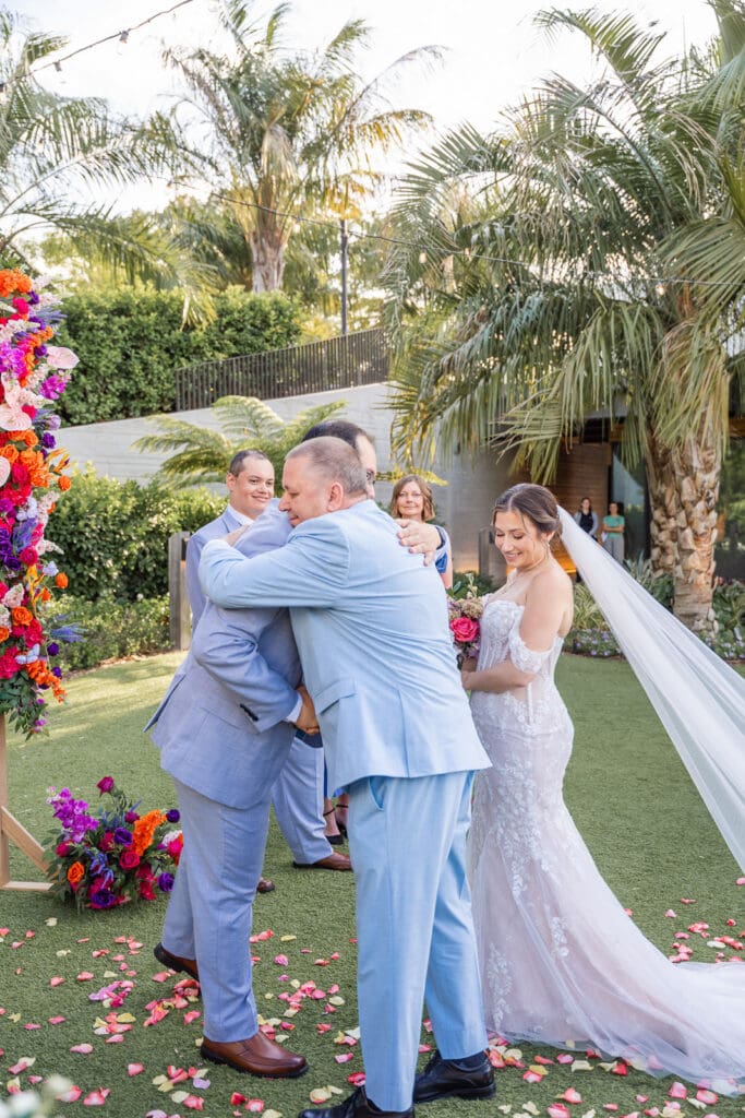 A heartfelt family embrace for bride giveaway at Evermore Resort in Orlando, captured naturally by Captured by Elle wedding photography