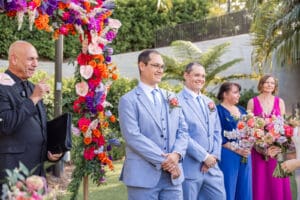 The groom smiles as guests gather for a romantic Evermore Resort wedding ceremony in Orlando, photographed by Captured by Elle, premier wedding photographer & videographer.
