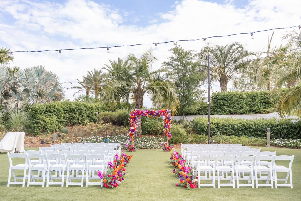 Elegant outdoor ceremony setup featuring colorful florals at Evermore Resort, one of Orlando's premier wedding venues, by Captured by Elle Photo & Video