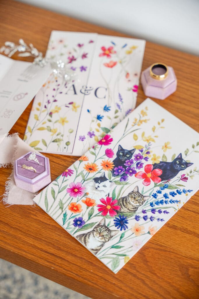 Custom wedding invitation suite with meaningful pet illustrations and rings at Evermore Resort, photographed by Orlando wedding photographer Captured by Elle