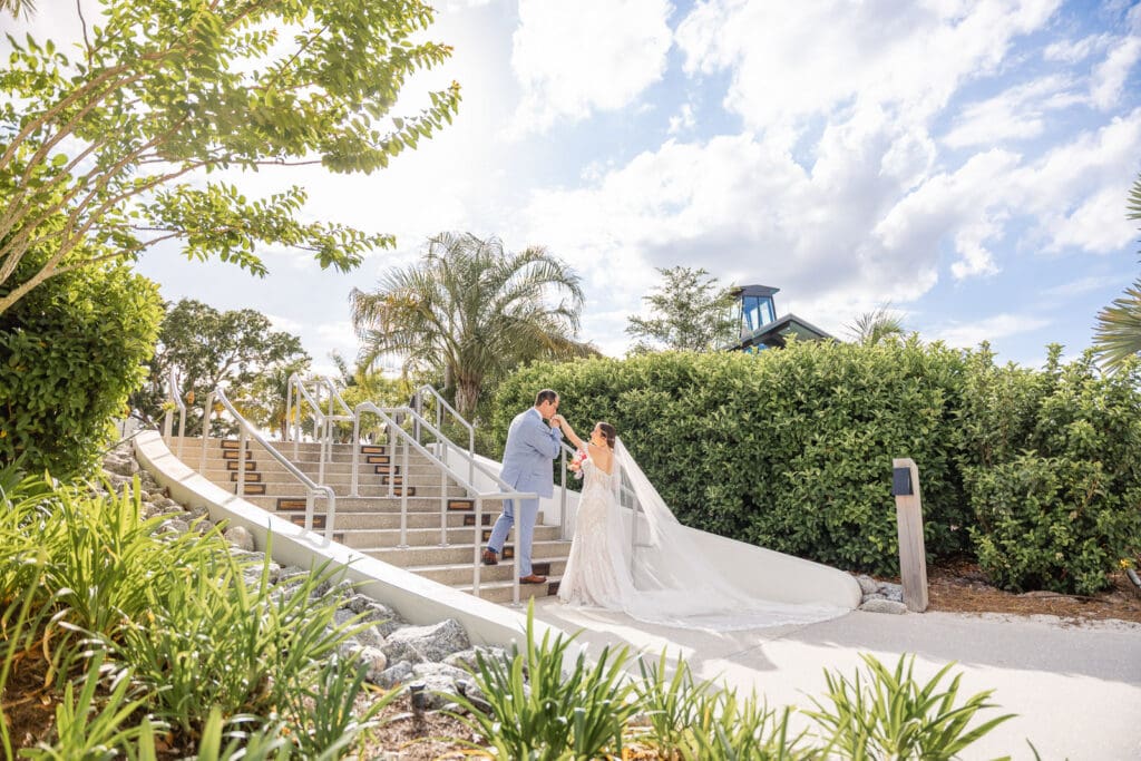 A timeless kiss on the scenic pathways of Evermore Resort in Orlando, captured by Captured by Elle, specializing in luxury wedding photography and videography